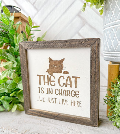 The cat is in charge we just live here. Laser engraved wood sign