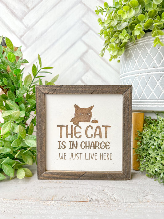 The cat is in charge we just live here. Laser engraved wood sign