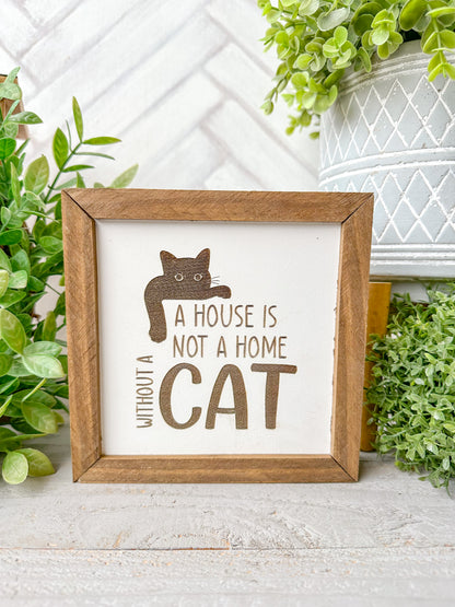 A house is not a home without a cat. Laser engraved wood sign.