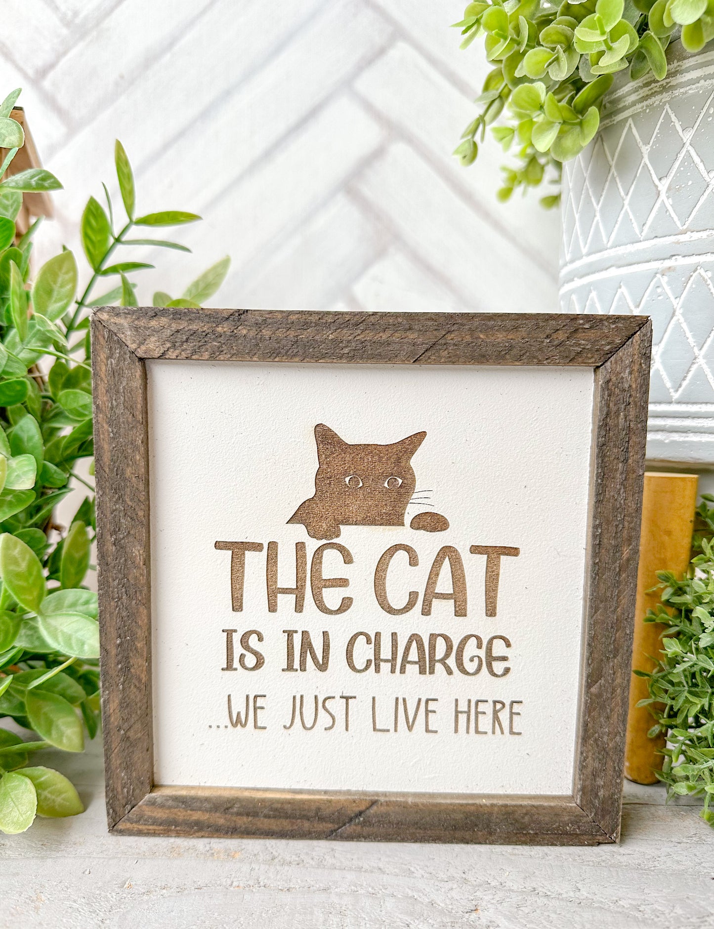 The cat is in charge we just live here. Laser engraved wood sign