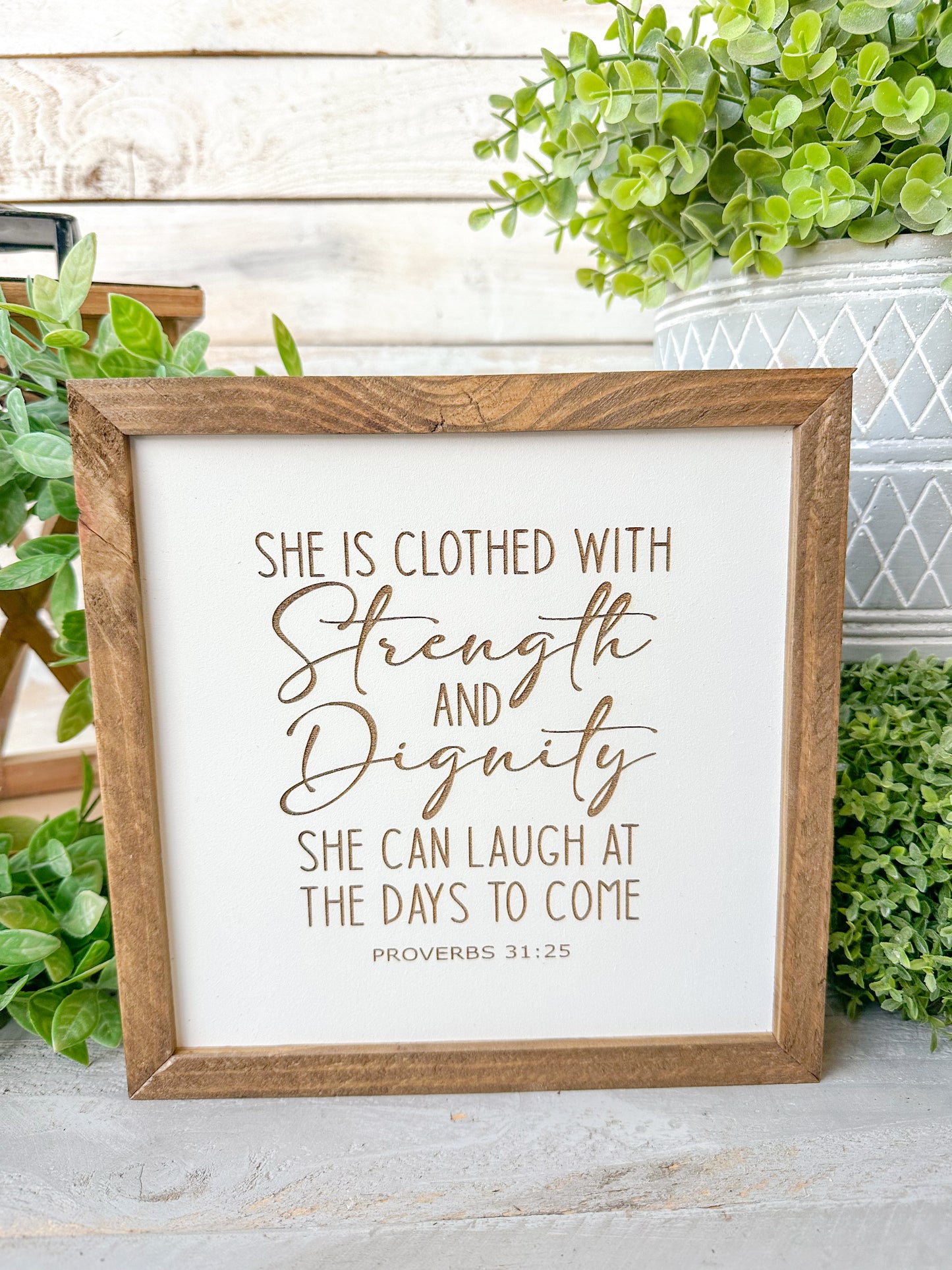 She is closed with strength and dignity. She can laugh at the days to come Proverbs 31:25. Laser engraved wood sign.