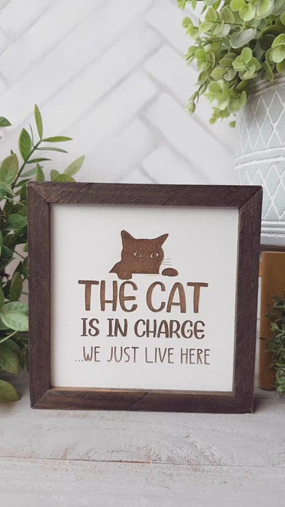 The cat is in charge we just live here. Laser engraved wood sign